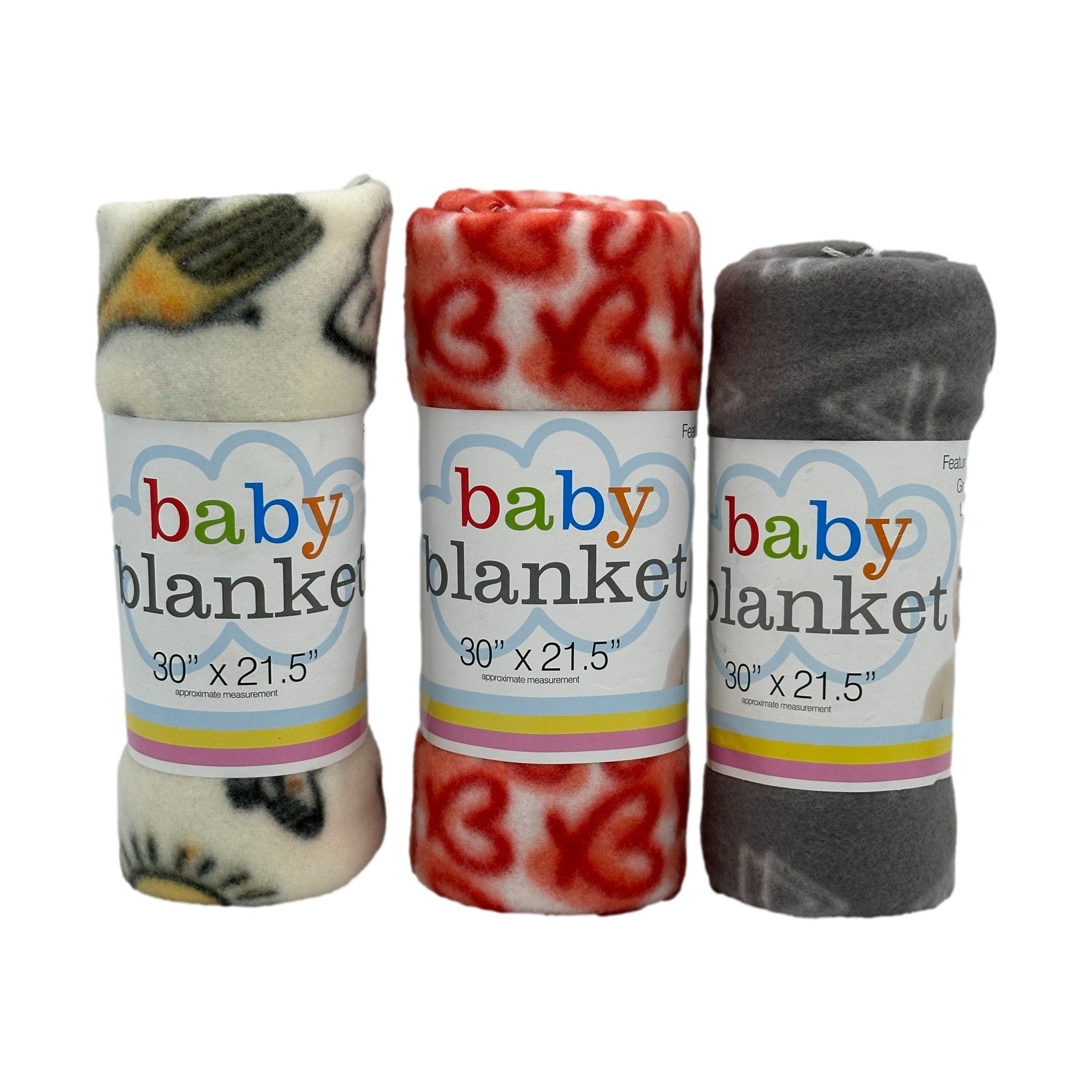 Three rolled baby blankets, each wrapped with a labeled paper band. One is off-white with a pattern, another is red and white with hearts, and the last is gray with white.